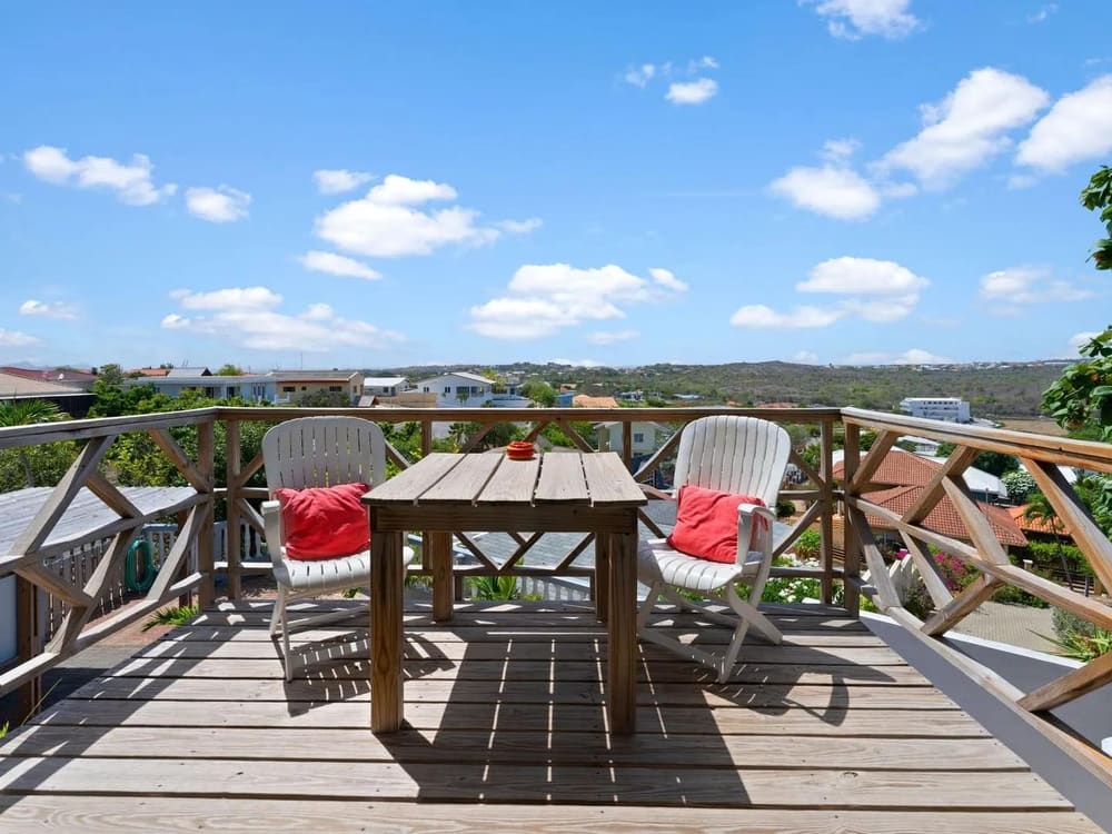 Apartment 2 balcony with seating and views over the hilltop